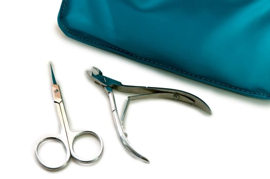 Blue beautician and nail scissors - manicure set on isolated background.