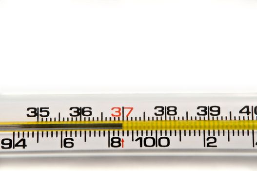 Close up of a mercury thermometer showing a normal human temperature reading. Arranged horizontally on white.
