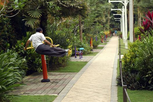 A jogging path way at garden guy working out on the machine