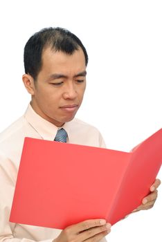 Sad businessman of Asian reviewing report on red folder with sorrowful expression on white background.