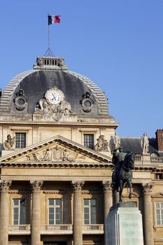 Exterior view of Les Invalides buildings and statues in Paris, France.