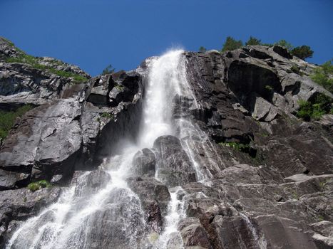 tall nordic waterfall and the blue sky (horizontal)