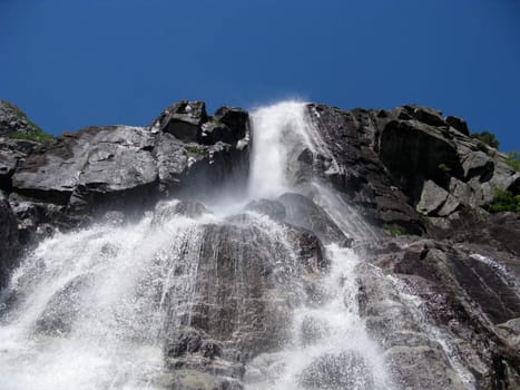 tall nordic waterfall and the blue sky (horizontal)