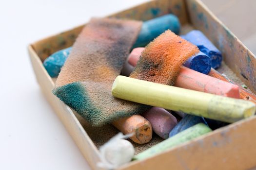 pastel crayon and other art tools on neutral background