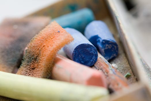 pastel crayon and other art tools on neutral background macro