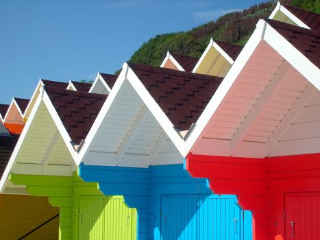 Exteriors of beautiful bright seaside beach chalets, Scarborough, England.