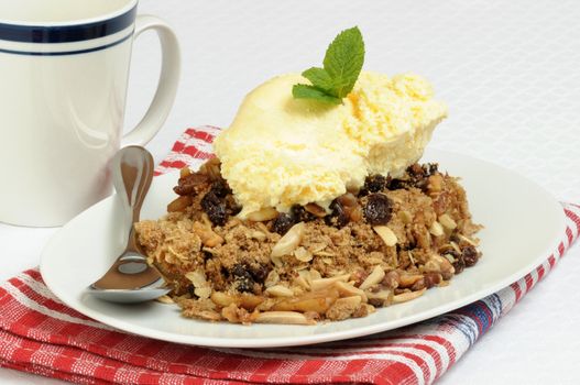 Hot apple crisp served with vanilla ice cream.