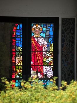 a stained glass window with a depiction of Jesus Christ in it.