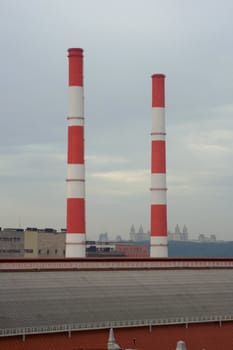 two tall striped chimneys towering over grey slate roof