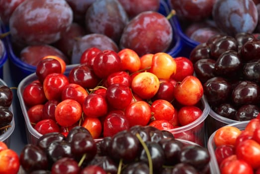 Sweet cherry in the street market in a plastic box. A close up.