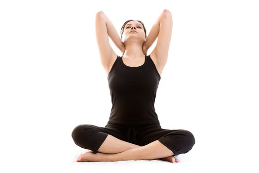 Young woman doing exercise over white background in black dress 