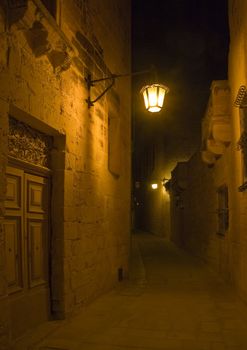 A lantern lit alley by night in Malta