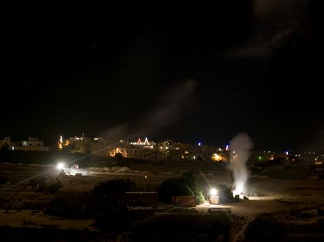 Workers in a fireworks factory in Malta letting off fireworks and hiding behind concrete blocks