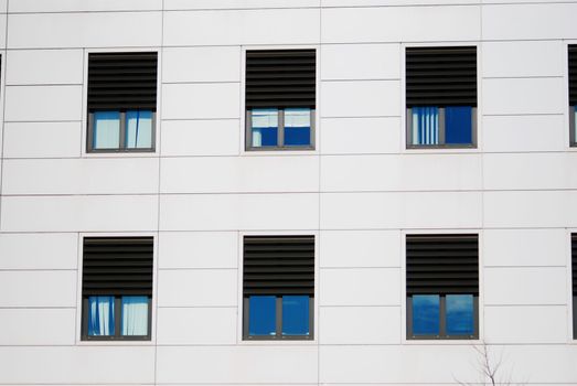 background of white wall of building with windows