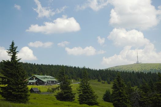 czech mountain with forest, blue sky and white cloud