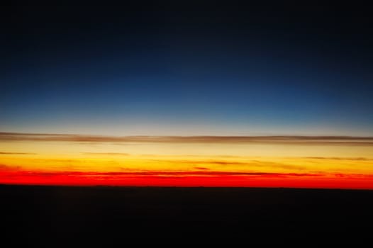 beautiful and corourful sunset above clouds, shot taken from plane