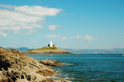 coast of Swansea in wales with lighthouse, horizontally framed shot