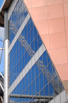 reflection of blue sky with clouds in windows of   Millennium Stadium in Cardiff