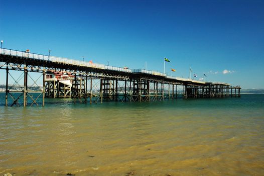 Swansea pierwith yellow water of sea and blue sky