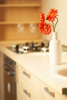 Beautiful flower on table in modern white kitchen