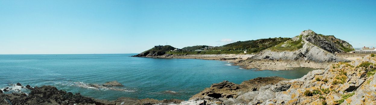 panorama of coast of Swansea in Wales with blue sky
