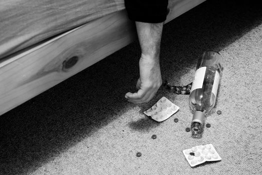 suicide in bed with pills and bottle of wine