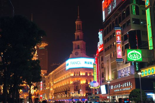 CHINA, SHANGHAI, NANJING ROAD - MAY 12, 2007: shopping paradise in China, famous Nanjing Lu with thousands of shops, neon lights, crowd of people.