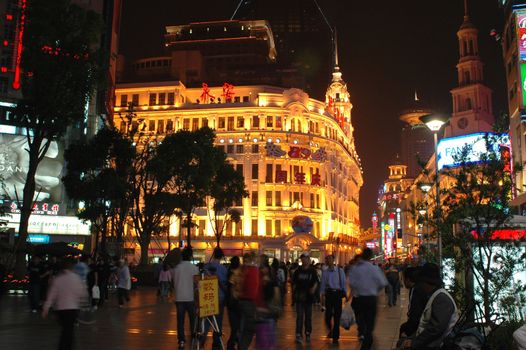 CHINA, SHANGHAI, NANJING ROAD - MAY 12, 2007: shopping paradise in China, famous Nanjing Lu with thousands of shops, neon lights, crowd of people.