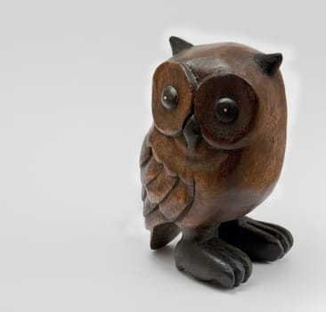 Wooden owl statue on a white background.