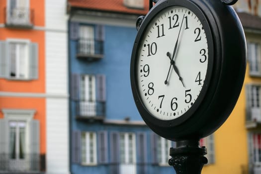 Street clock at five pm, in Locarno Switzerland.
