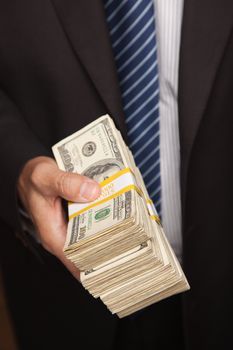 Businessman Handing Over Stack of One Hundred Dollar Bills.