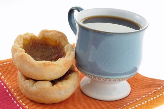 Fresh baked butter tarts with a cup of coffee.