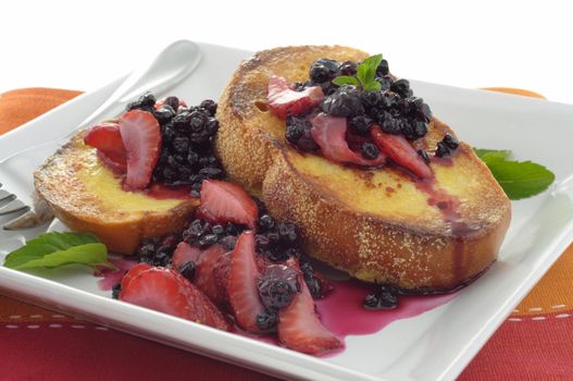 French toast topped with seasonal berries and mint.