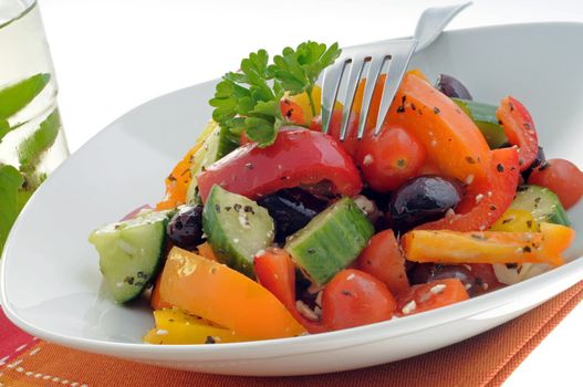 Colorful and tasty vegetable salad in a white bowl.