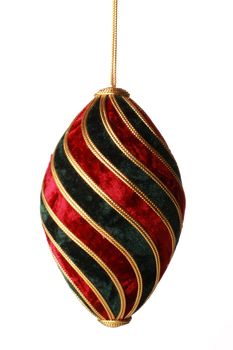 A christmas ball hanging from golden thread, shot in studio isolated on white.  Perfect for your holiday designs or ads