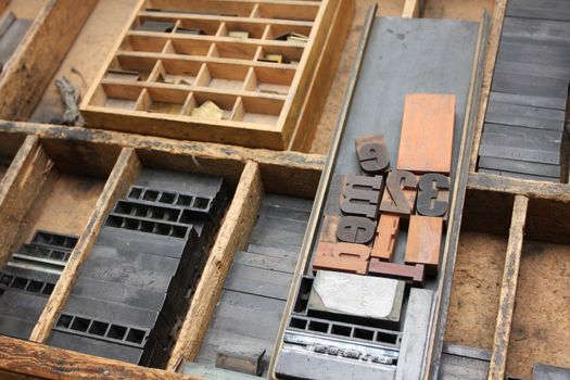 An old fashioned type setters workshop, the tools and typescripts lying in a worktop