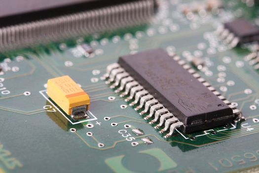 close up of a electronic hardware, silicon chips on a green board
