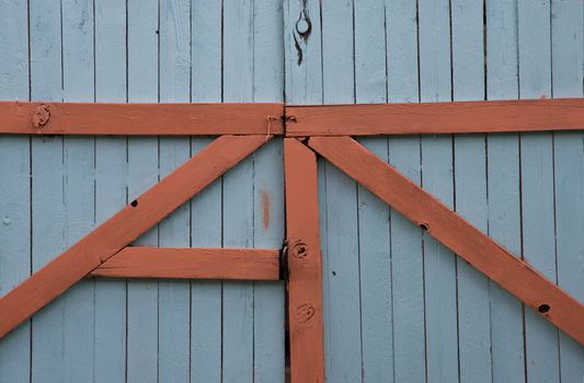 A blue gate with terra cottal trim.