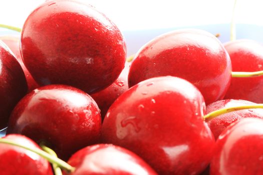 Fresh red cherries in a bowl, high key lighting