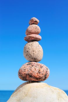 A stack of round pebbles on background the sky