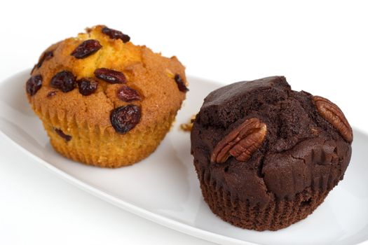 two muffins on a plate, shallow DOF, isolated
