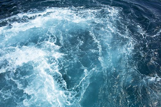 Photo taken from boats. Engine pushing powerful streams of water, creates a wonderful patterns on the surface.