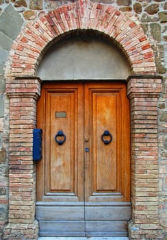 A set of ancient wooden doors in Tuscany, Italy.
