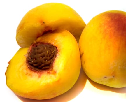 Yellow peaches on the white background. Isolated.