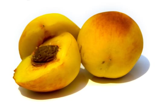 Yellow peaches on the white background. Isolated.