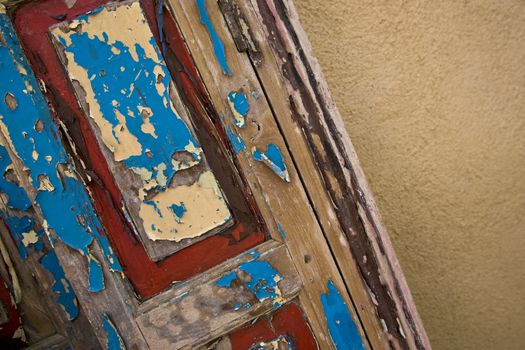 A detail of an old painted wooden door.