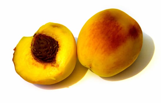 Yellow peaches on the white background. Isolated.
