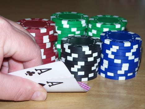 great poker hand shows pair of aces and poker chips