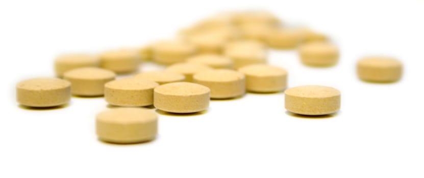 Tablets of beige color on white background. Isolation, shallow DOF