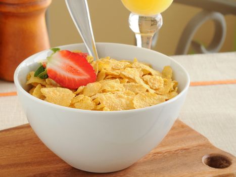 Bowl of crunch corn flakes with strawberries.